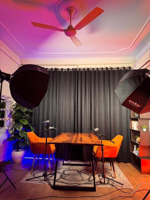 Grey wall armchair interview setup at Spettro Studios, Rajouri Garden